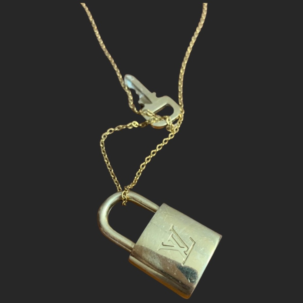 Authentic Louis Vuitton lock and key set in gold hardware with gold chain